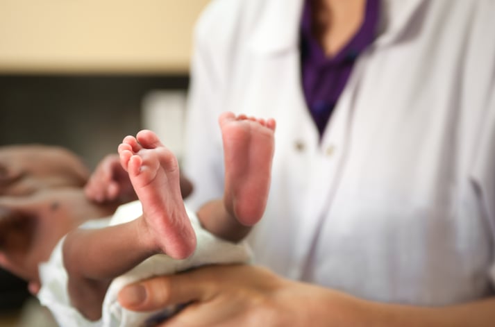 nurse holding baby breastfeeding.jpg