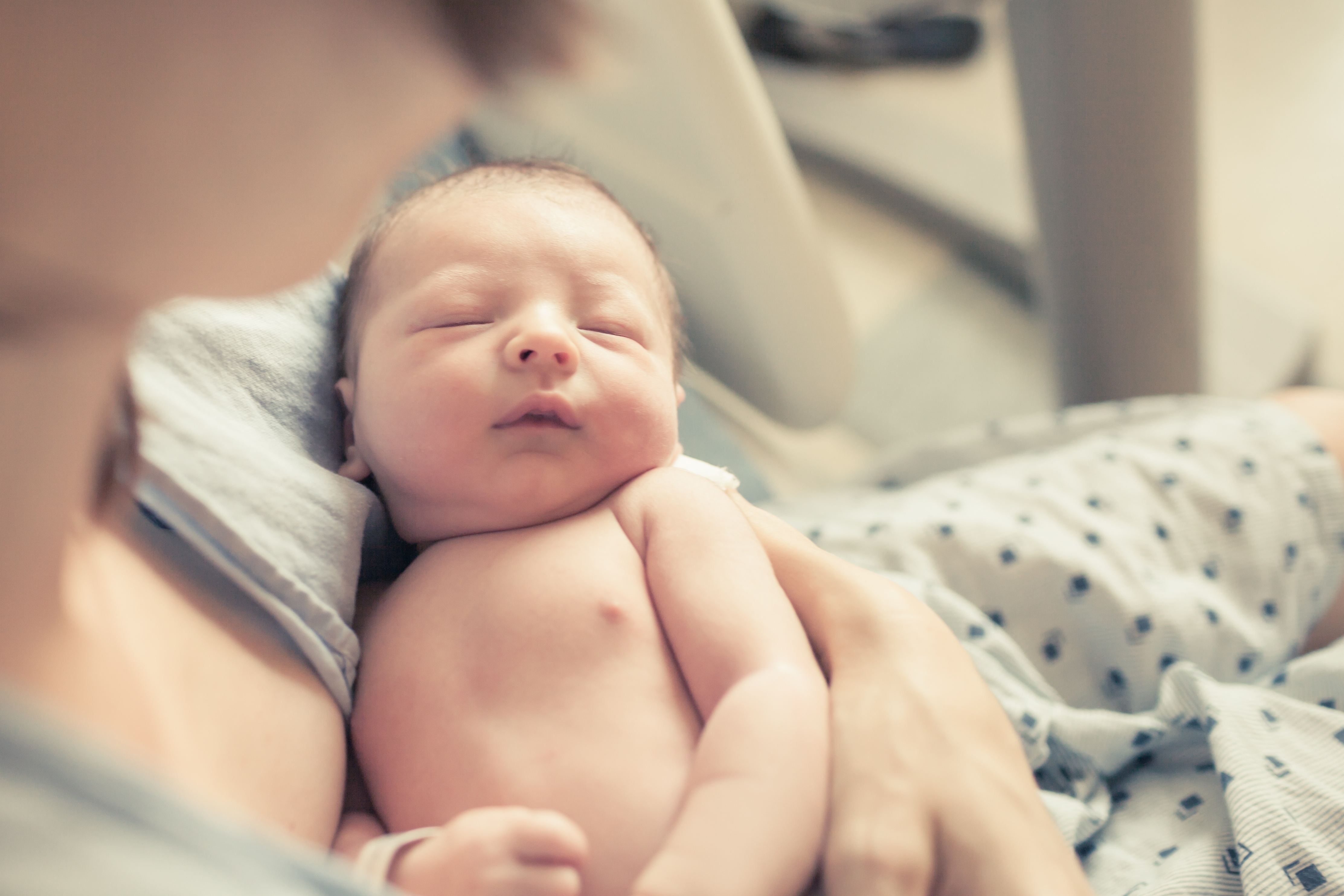 baby in moms arms in hospital