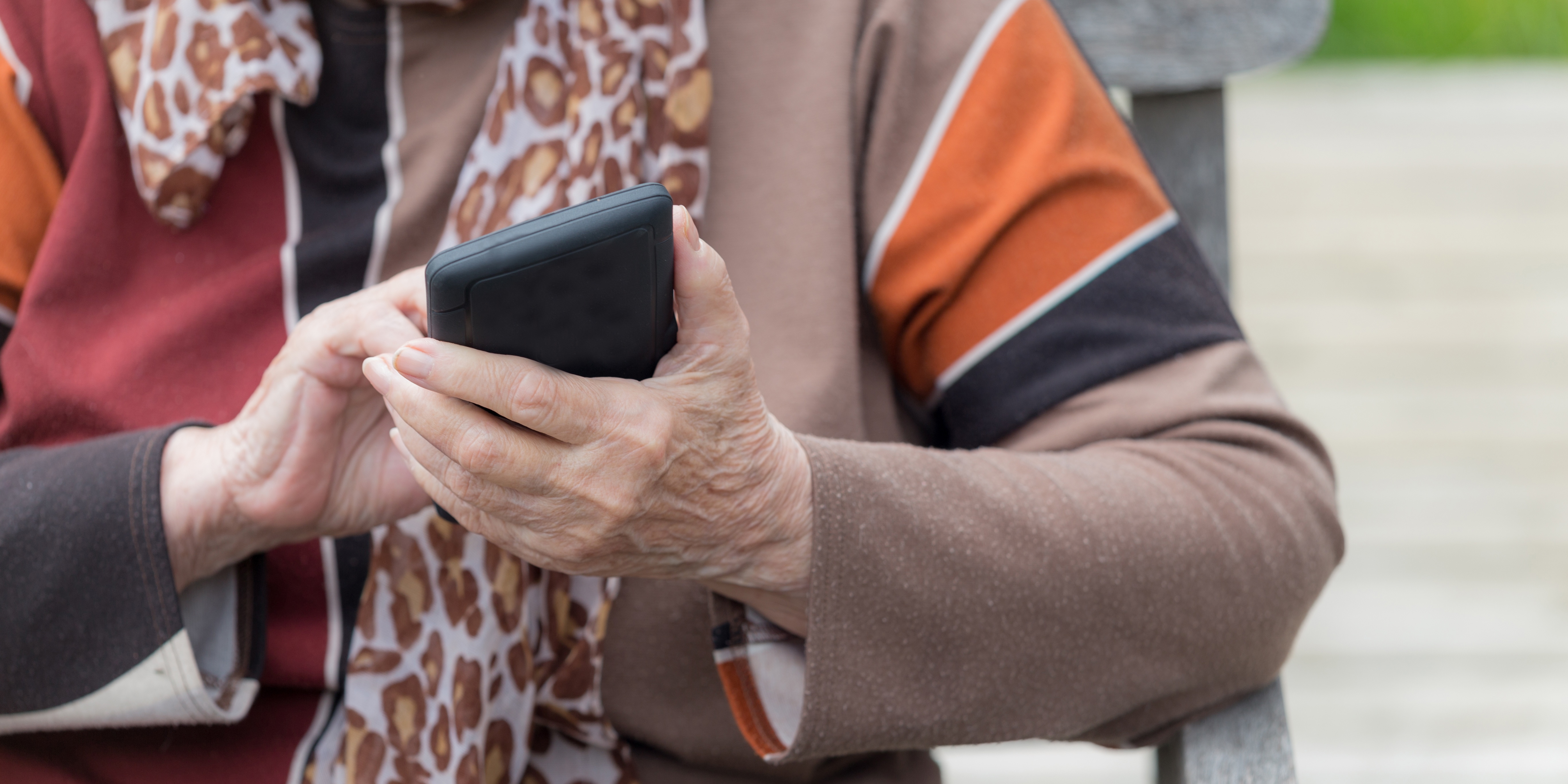 older woman hand with phone